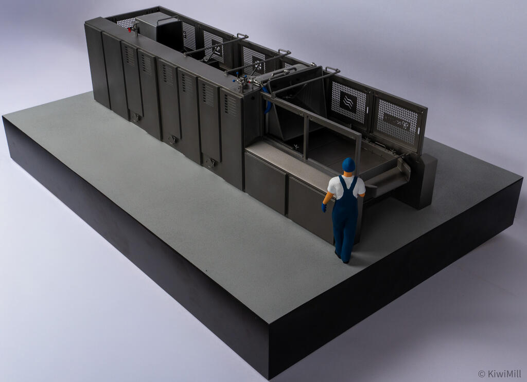Cooking line model seen from behind the loading end, worker figure facing the open infeed and raised guard panels